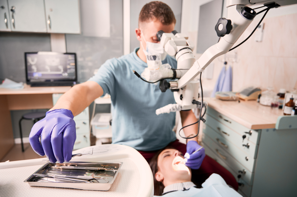 male-dentist-grabbing-dental-explorer-dental-procedure.jpg