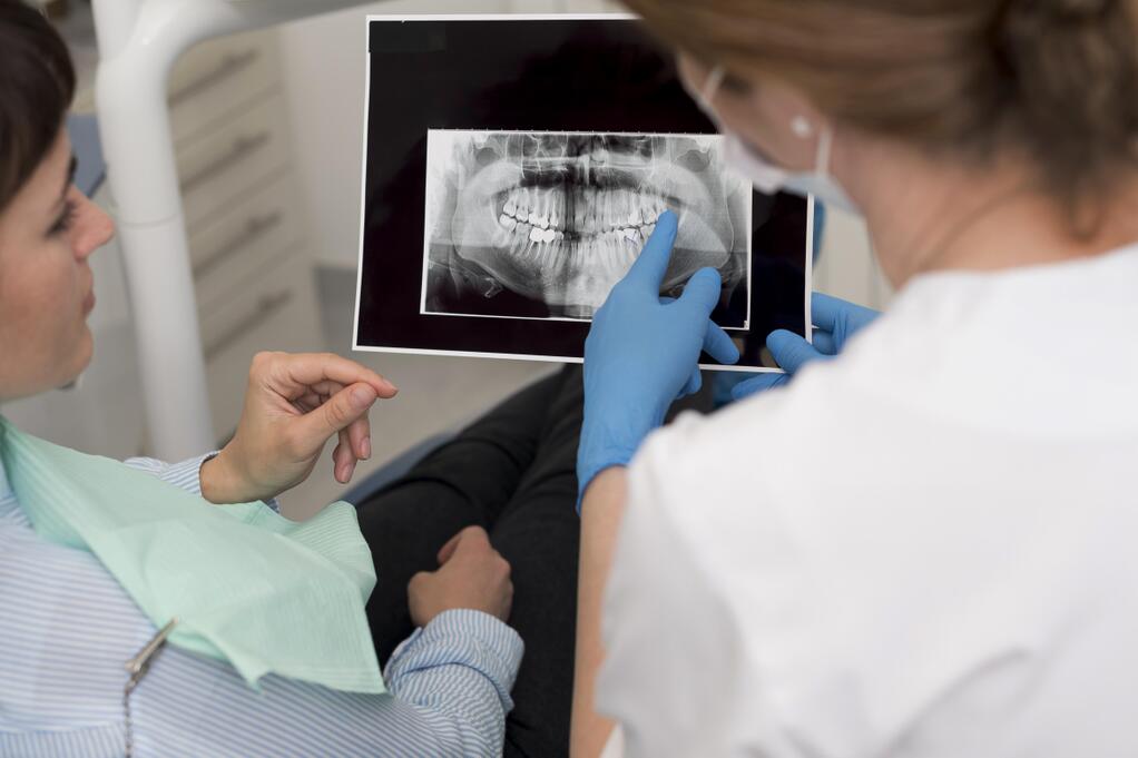 female-patient-looking-radiography-her-teeth-with-dentist.jpg